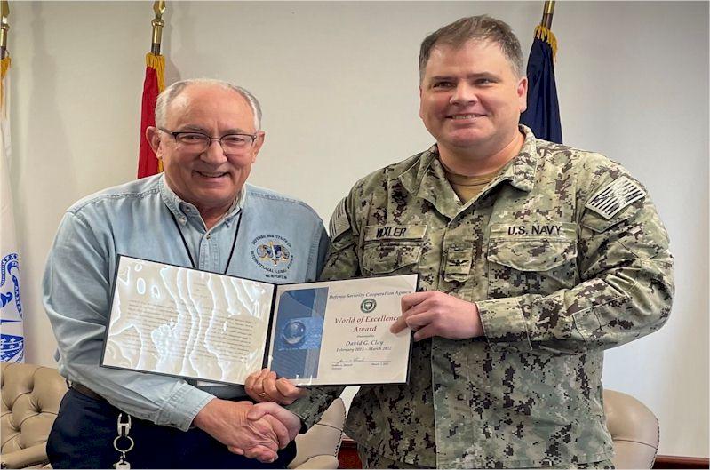 Mr. David Clay receiving a retirement certificate