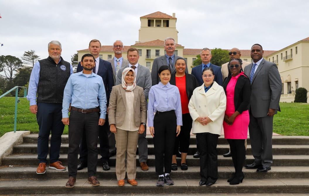 group of people in formal attires standing in front of tall building